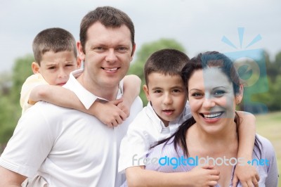 Beautiful Couple Carrying Their Kids On Their Back Stock Photo