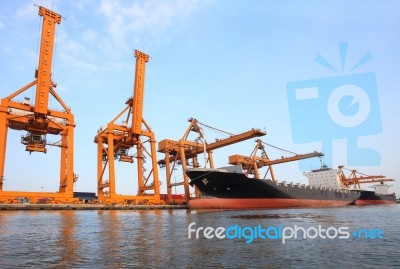 Big Container Ship On Port With Big Pier Lifting Crane  Use For Stock Photo