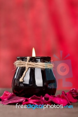 Black Candle Cup On Red Background Stock Photo