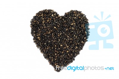 Black Sesame In Heart Shape Stock Photo