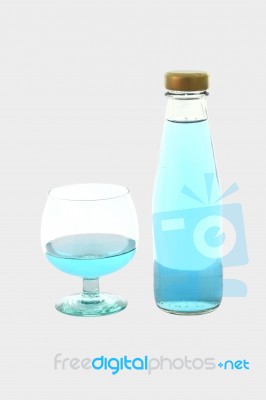 Blue Beverage Drinking Glass And Bottle On Gray Background Stock Photo