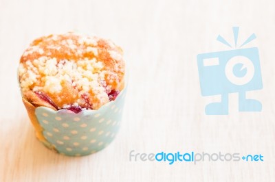 Blueberry Muffins In Paper Cupcake On Wooden Background Stock Photo