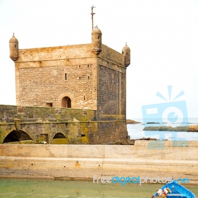 Boat And Sea In Africa Morocco Old Castle Brown Brick  Sky Stock Photo