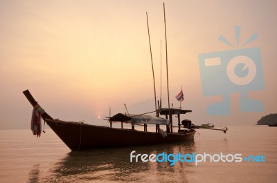 Boat In Ocean At Sunrise Stock Photo
