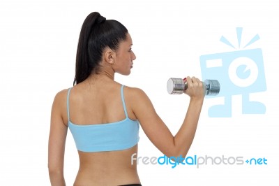 Body Of Slim Female In Activewear Doing Exercise With Dumbbells Stock Photo