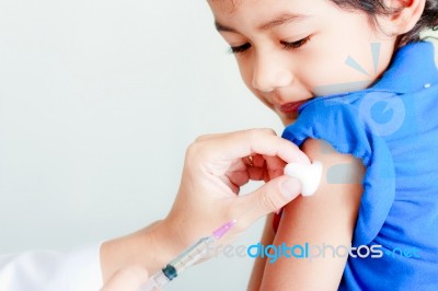 Boy And Vaccine Syringe Stock Photo
