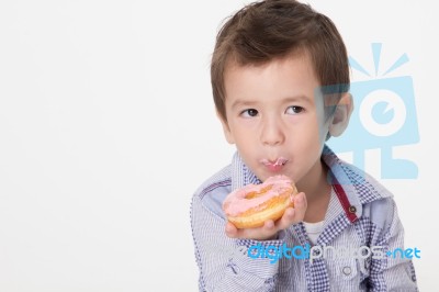 Boy Eating A Donut Stock Photo