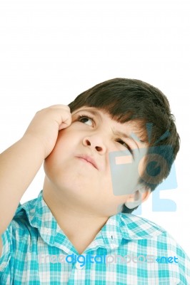 Boy Looking Up And Scratches Head Stock Photo