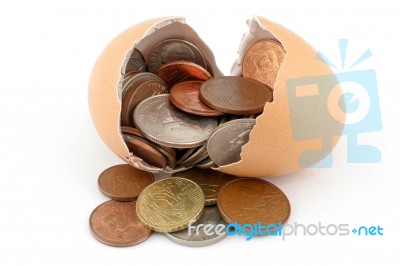 Broken Egg With Coins Stock Photo