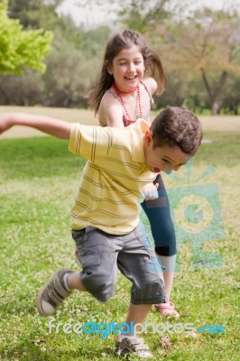 Brother Pulling His Sister Stock Photo