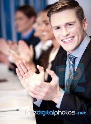 Business Associates Applauding, Focus On Guy Stock Photo