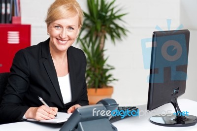 Business Executive Writing Her Appointments Stock Photo