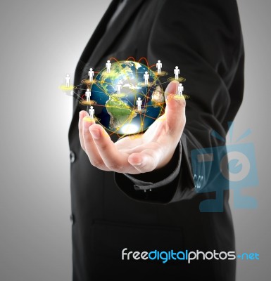 Business Man Holding The Small World In His Hand Stock Photo