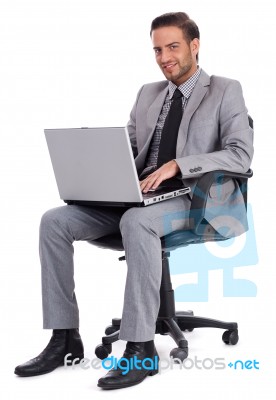 Business Man Sitting With Laptop And Smiling Stock Photo