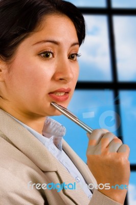 Business Woman In Her Office Thinking Stock Photo