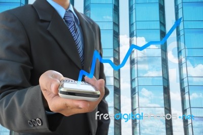 Businessman And Mobile Graph Stock Photo