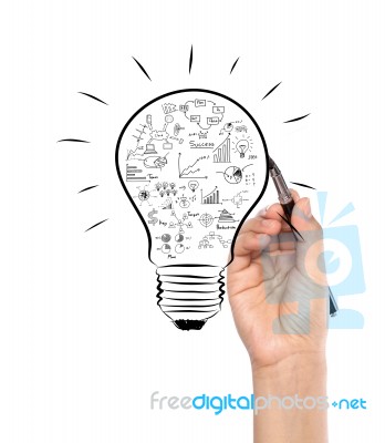 Businessman Hand Drawing Business Concept In Bulb Stock Photo