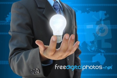 Businessman Hand Holding Light Bulb Stock Photo