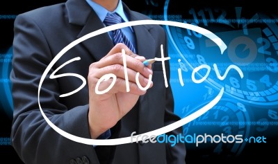 Businessman Hand Writing Solution Stock Photo