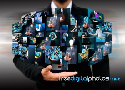 Businessman Holding Reaching Images Streaming In Hands Stock Photo