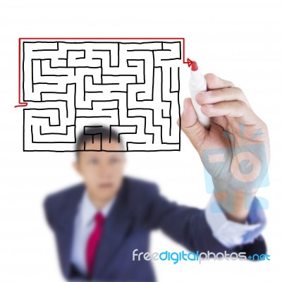 Businessman Look Up And Writing Exit From Maze Problem Stock Photo