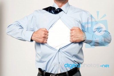 Businessman Pulling His T-shirt Open Stock Photo