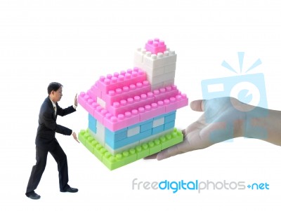 Businessman Pushing House Stock Photo