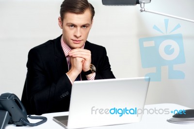 Businessman Sitting In Front Of Laptop Stock Photo