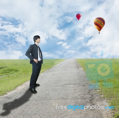Businessman Standing On Rough Way Stock Photo