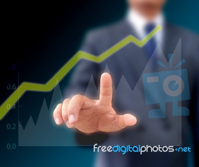 Businessman Watching The Upward Trend Of A Graphic Chart Stock Photo