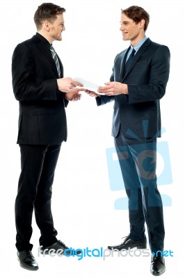 Businessmen Evaluating Deal Documents Stock Photo