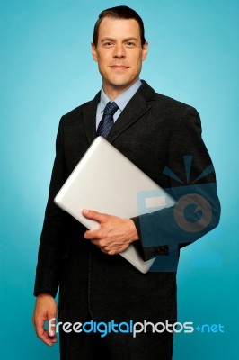 Businessperson Holding Laptop Stock Photo