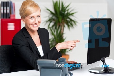 Businesswoman Pointing At Computer Stock Photo