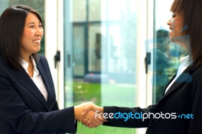 Businesswomen Shaking Hands Stock Photo