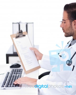 Busy Doctor Working With His Reports Stock Photo