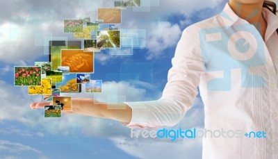 Button Streaming Multimedia In Hand On Blue Sky Stock Photo