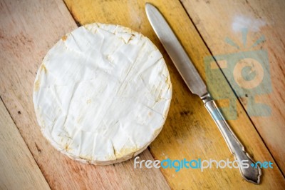 Camembert Cheese And Vintage Knife On Wooden Table Stock Photo