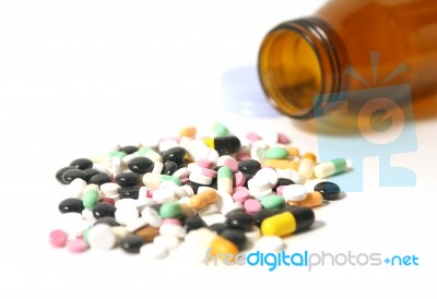 Capsules With Open Bottle  Stock Photo