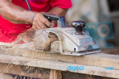 Carpenter Working With Electric Planer Stock Photo