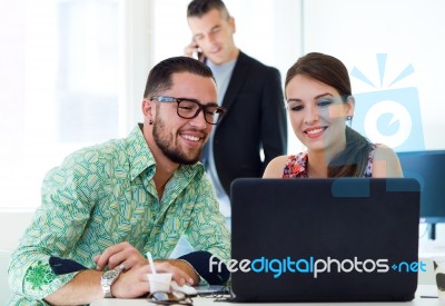 Casual Executives Working Together At A Meeting With Laptop Stock Photo