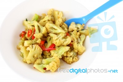 Cauliflower Fried With Chili And Blue Spoon Stock Photo
