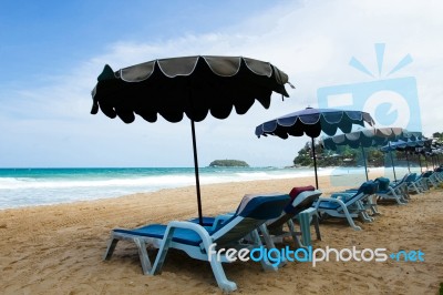 Chairs And Umbrellas On The Beach Stock Photo