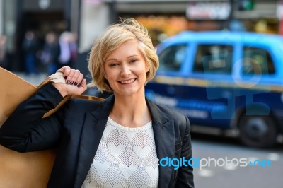 Cheerful Business Woman Holding Shopping Bag Stock Photo