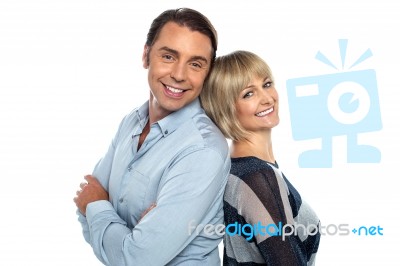 Cheerful Couple Leaning On Each Other Stock Photo
