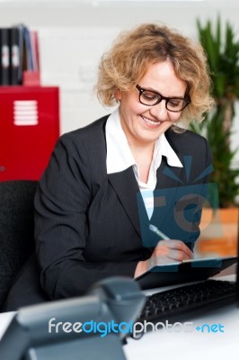 Cheerful Office Worker Writing Notes Stock Photo