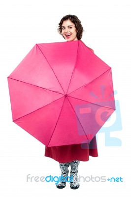 Cheerful Woman Being Playful With Umbrella Stock Photo