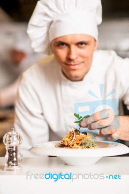 Chef Arranging Pasta Salad In A White Bowl Stock Photo