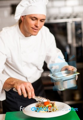 Chef Arranging Tossed Salad In A Bowl Stock Photo