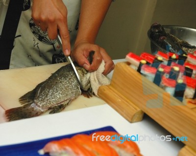 Chef Cutting Fish For Sushi Stock Photo