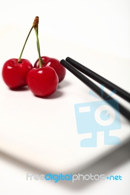 Cherry And Chopstick Stock Photo